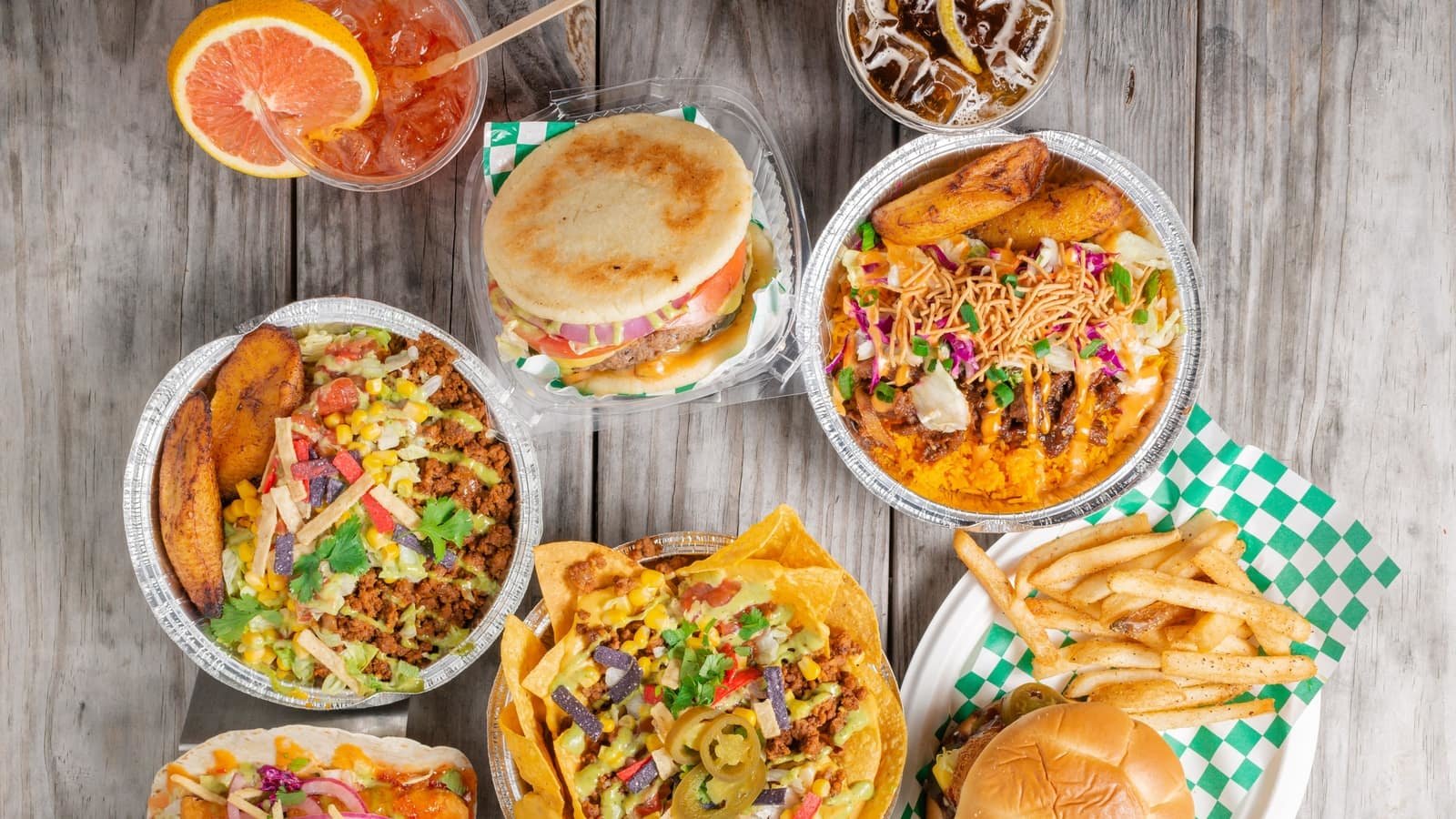 spread of food including burgers, bowls, and nachos